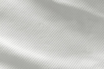 A close-up top view of the texture of a white sports fabric jersey football shirt.