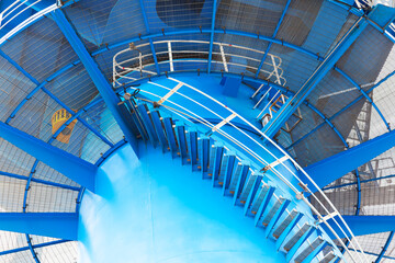 Spiral staircase of a large port crane with a transition platform, bottom view.