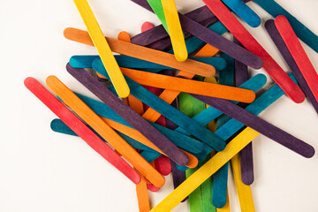 multicolored sticks scattered on a white background, background with colorful sticks, colorful...