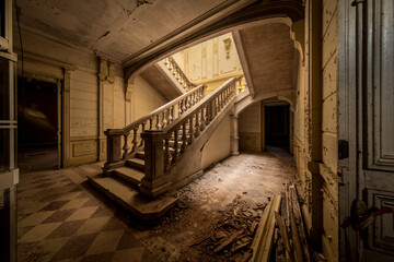 A dominating stair well in an abandoned hotel