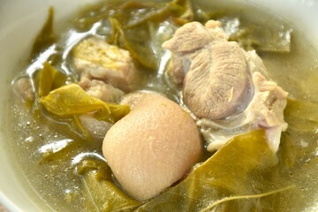 boiled pork leg and belly with cowa leaf soup on bowl