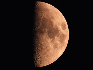 moon in the waxing half moon phase with clouds