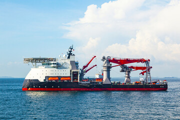 Multi-purpose supply vessel is anchored in a sea bay.