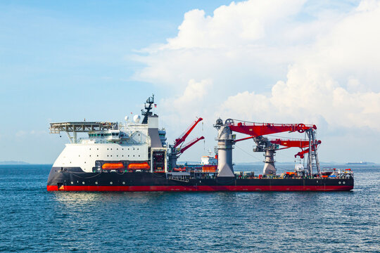 Multi-purpose supply vessel is anchored in a sea bay.