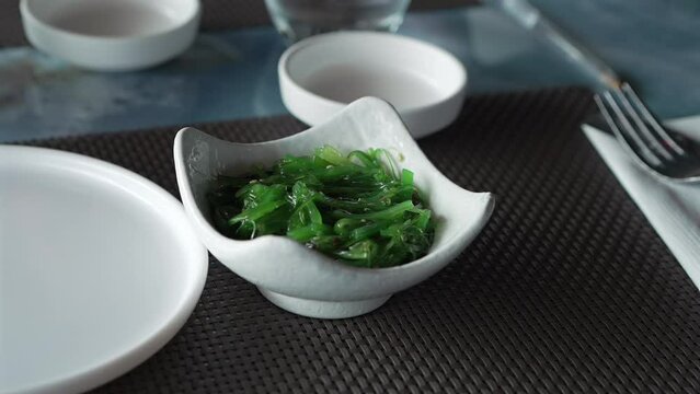 A bowl of Wakame seaweed salad close up, typical dish in East Asia.shot at 60 fps