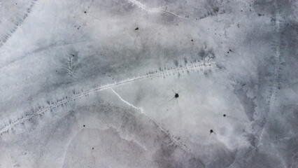 Frozen lake from above, ice structure. Winter pranks