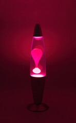 Lava lamp lavalamp red purple volcano color isolated retro vintage style from the 1960s and 1970s, hippie peace generation interesting heated wax in liquid oil water forms bubble globs that suspend - obrazy, fototapety, plakaty