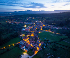Winter landscape of the town of Santillana del Mar at dusk seen from a drone. Municipality of...