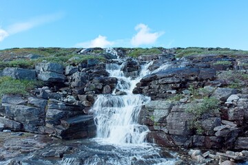 Waterfall on the side of mountain in summer, Storfjord, Norway.