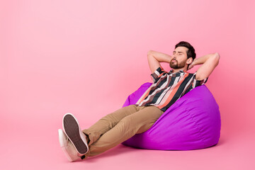 Full length body photo of take nap man chill out sleeping carefree on comfortable beanbag lounge room isolated over pink color background - obrazy, fototapety, plakaty