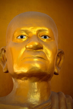 Golden Statue of a monk symbolic image head and face closeup Thailand