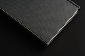 Black hardcover book or notepad mock up on black background