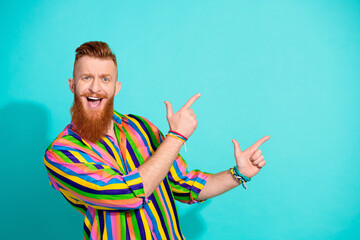 Photo of young handsome red hair man wearing glamour striped shirt direct fingers copyspace banner...