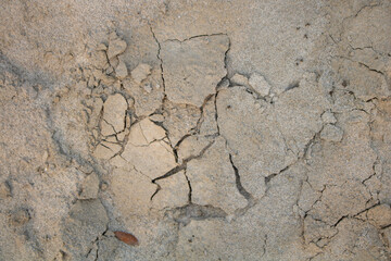 Sand layers on river banks. Alluvial soil has dried and cracked. It can be used as background or texture for design.