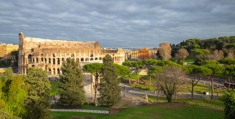 Fototapeta na wymiar the colosseum under golden sunshine in Rome, Italy, tourist, travel, header photo