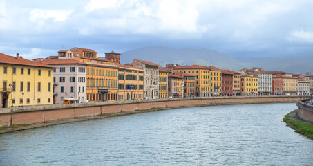Fototapeta na wymiar Arno riverbank buildings in Pisa, Italy