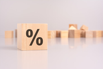 percent sign on wooden block, gray background