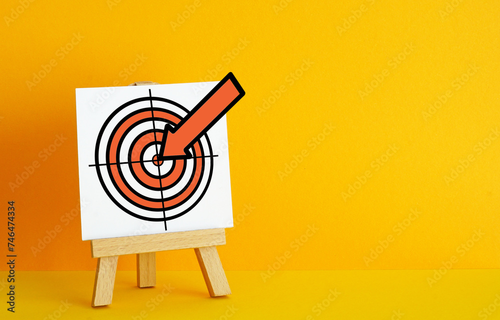 Poster archery target on a orange background. the concept of fulfilling the goal, striving to implement pla