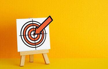 Archery target on a orange background. The concept of fulfilling the goal, striving to implement...