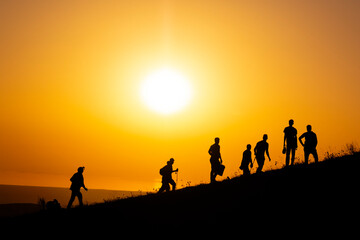 group of people running on the beach