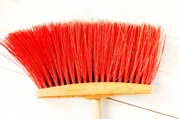 Red mop on wooden background. Top view, flat lay