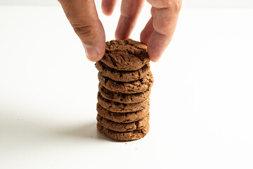 stack of dark chocolate cookies isolated on a white background