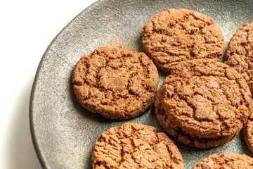 chocolate cookies on a dish isolated on a white background