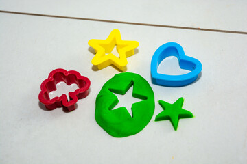 child playing with play dough on the floor at home