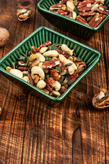 Mixed nuts on wooden background.