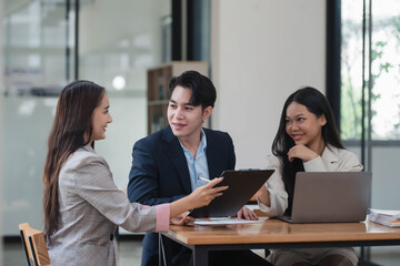 Young smart manager giving his advice to the business team in the meeting room.