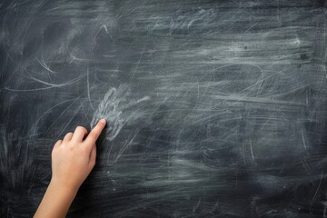 Hand on blackboard background, study, learning concept.