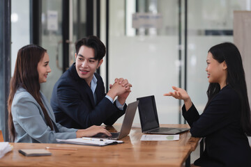 Successful team of business people brainstorming the ideas together in the meeting room.