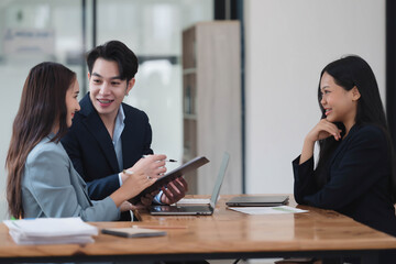 Cheerful business people discussing the project together in the meeting room.