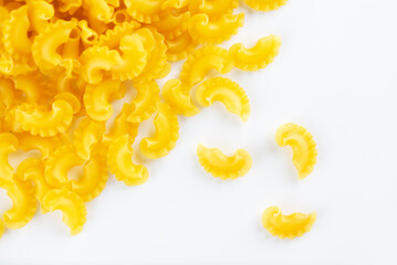 Creste Di Gallo raw pasta on a white background. Rooster scallop. Top view.