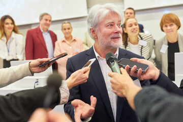 Business speaker talking to journalists during business conference