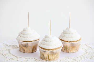 Three Vanilla Cupcakes Topper Mockup. 3 cupcake with wooden toothpick in white background Copy...