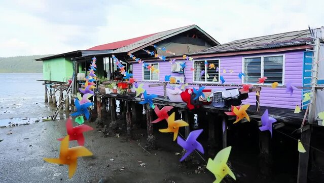 Fishing village houses over the water garbage poor areas in Sabah province in Malaysia