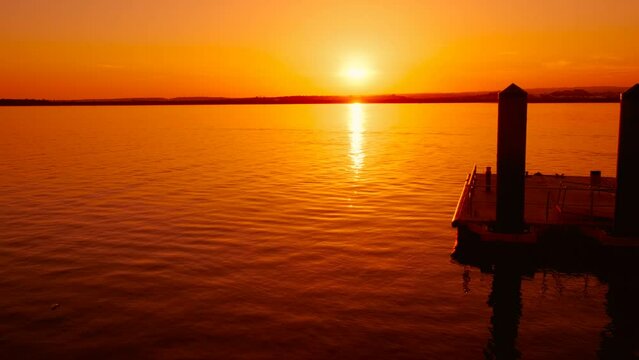 Sunset over the Guadiana River off the coast of Ayamonte, Huelva, Andalucia, Spain, paints the sky in vibrant colors, mirrored by tranquil waters