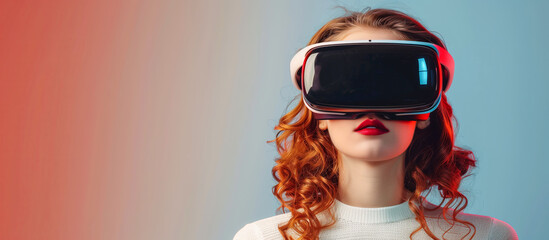 Young woman with red hair wearing virtual reality glasses on a gradient background. VR, AR and digital technology concept. Copy space for advertising banner or poster design