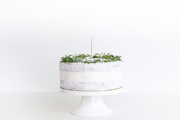 White cake and blank white background space on slice and greenery leafs , white cake topper mockup with toothpick