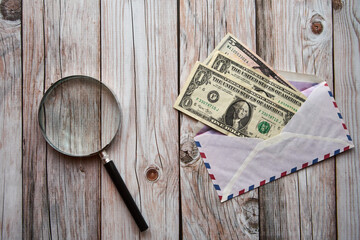 dolary amerykańskie w kopercie ,lupa  - obrazy, fototapety, plakaty