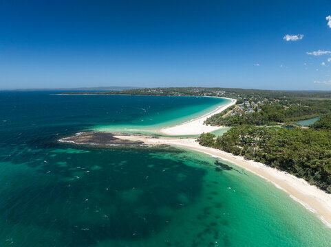 High angle aerial drone view of Huskisson Beach and Collingwood Beach in Huskisson and Vincentia, beachside suburbs in Jervis Bay Territory and on the South Coast of New South Wales, Australia.