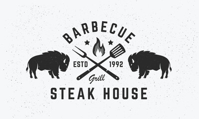 Steak House, barbecue restaurant logo, poster. BBQ trendy logo with spatula, grill fork and Bison silhouette. Vector emblem template.