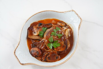 Slowly stewed beef tongue with mushrooms and onions