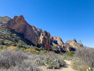 An empty desert trail under some sandstone cliffs and mountains in Big Bend National Park in Texas. Beautiful Southwestern American travel destination.