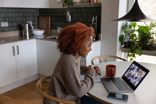 Young adult woman on a video conference call with colleagues working from home