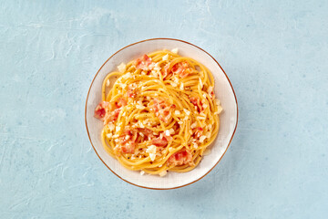 Carbonara pasta dish, traditional Italian spaghetti with pancetta and cheese, overhead flat lay shot