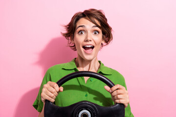 Photo portrait of attractive young woman excited driving car rudder dressed stylish green clothes...