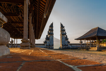 A view from inside Lempuyang Temple looking towards the Bali Gates of Heaven during sunset in...