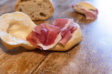 bread and sandwich with ham on a table